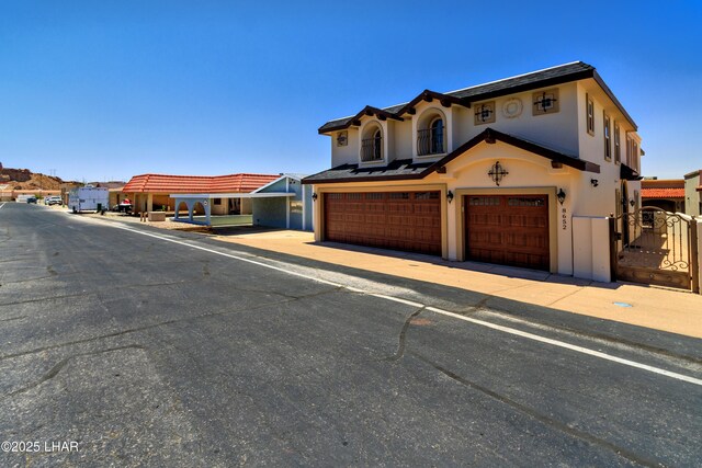 8652 Hopi Dr, Parker, AZ 85344 - view of front of property with a garage and stucco siding