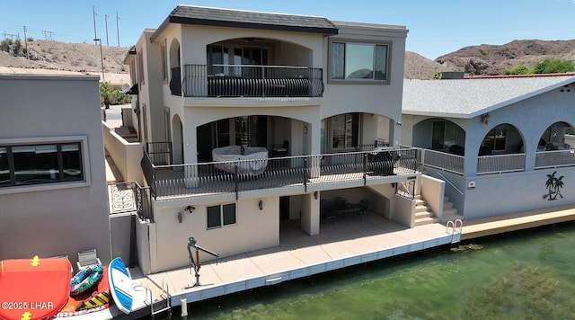 8652 Hopi Dr, Parker, AZ 85344 - back of property with a balcony, stucco siding, and a mountain view