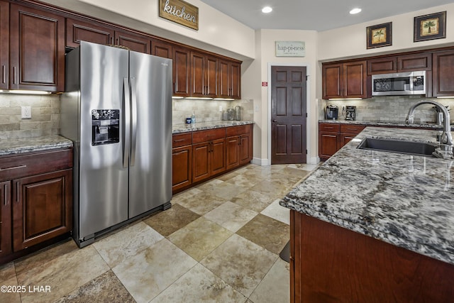8652 Hopi Dr, Parker, AZ 85344 - kitchen featuring appliances with stainless steel finishes, decorative backsplash, stone countertops, and recessed lighting