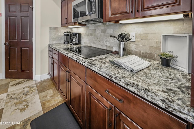 8652 Hopi Dr, Parker, AZ 85344 - kitchen with stainless steel microwave, black electric stovetop, tasteful backsplash, and light stone countertops