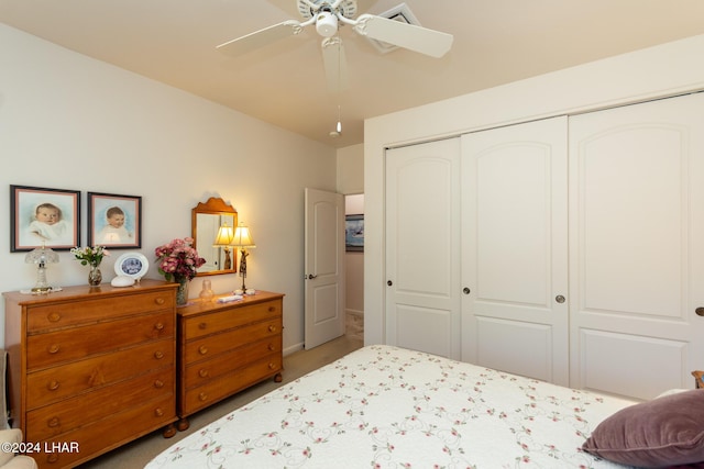 bedroom featuring ceiling fan, a closet, and carpet