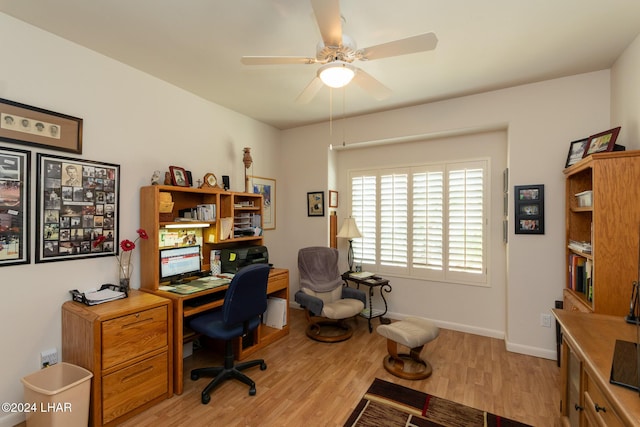 office space featuring light wood-style flooring, baseboards, and a ceiling fan