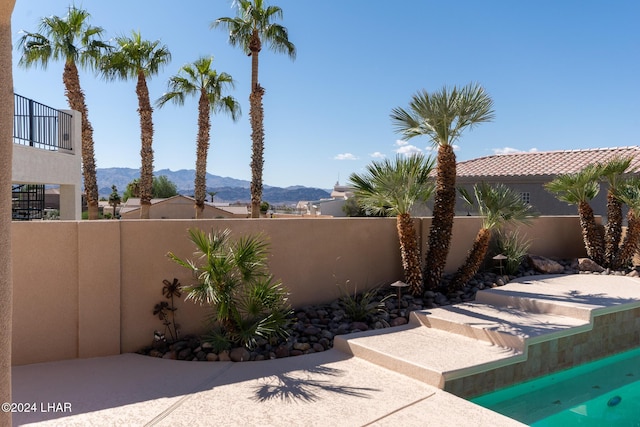 view of patio / terrace with a fenced backyard and a mountain view