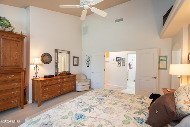 bedroom with a towering ceiling and visible vents