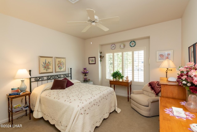 carpeted bedroom featuring baseboards and a ceiling fan