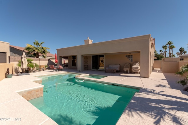 view of pool featuring a fenced in pool, a patio area, a fenced backyard, and an in ground hot tub