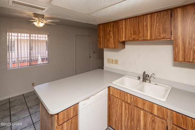 2301 Mcculloch Blvd N Unit E, Lake Havasu City, AZ 86403 - kitchen featuring dishwasher, a peninsula, a sink, light countertops, and brown cabinets