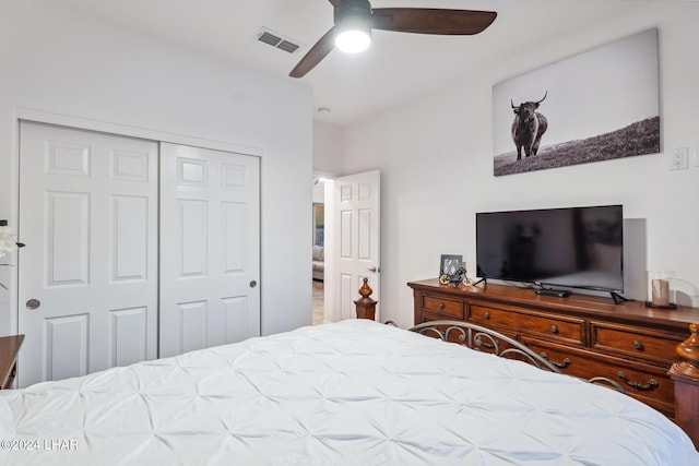 bedroom with ceiling fan and a closet