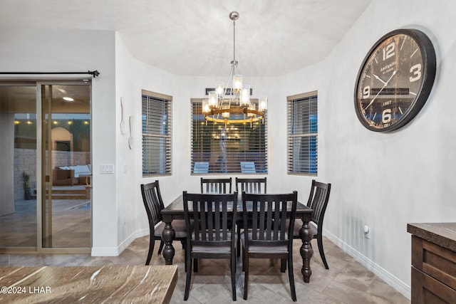 dining space with a notable chandelier