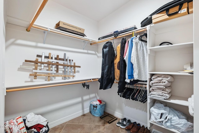 spacious closet featuring light tile patterned floors