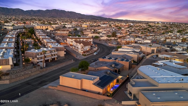 aerial view at dusk featuring a mountain view