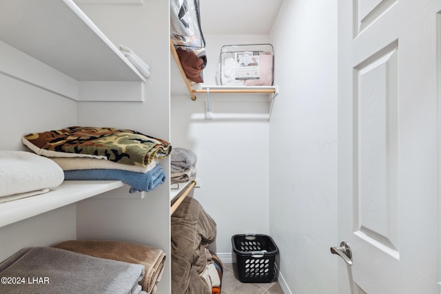 walk in closet featuring tile patterned flooring