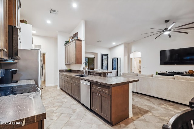 kitchen with sink, vaulted ceiling, stainless steel dishwasher, and ceiling fan