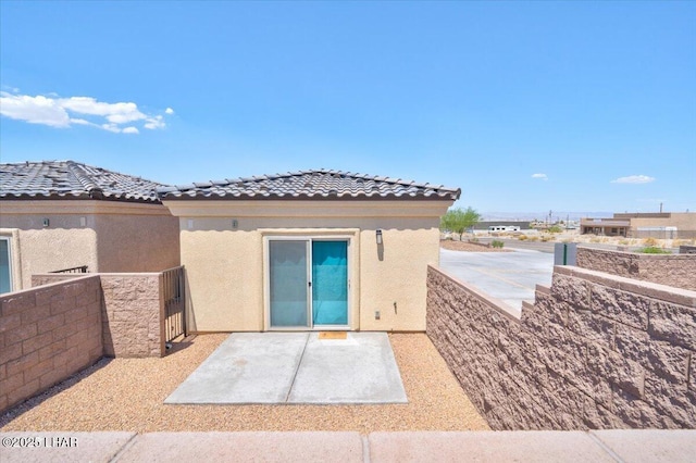 2950 N Kiowa Blvd Unit A101, Lake Havasu City, AZ 86404 - rear view of property with stucco siding, a patio, and a tile roof
