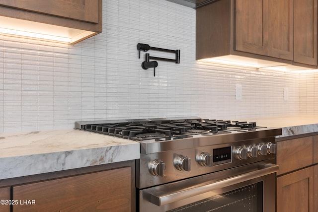 kitchen featuring tasteful backsplash and stainless steel range with gas stovetop