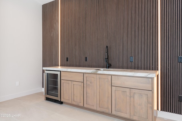 interior space featuring wine cooler, light tile patterned flooring, and light brown cabinets