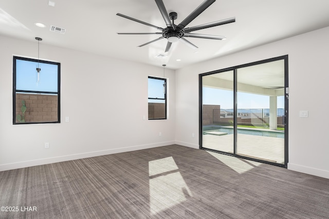 carpeted empty room featuring ceiling fan