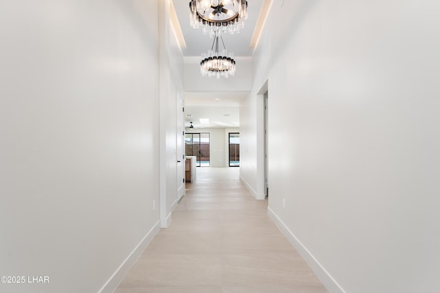 corridor with a notable chandelier