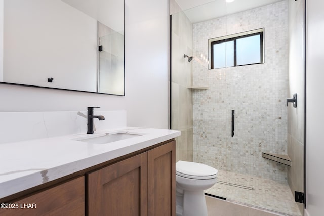 bathroom with vanity, toilet, and walk in shower