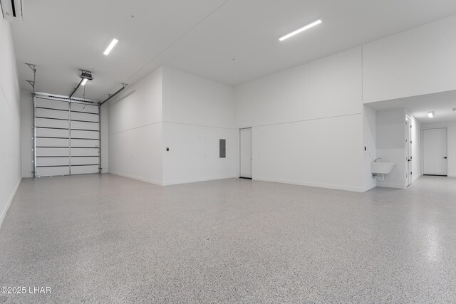 garage featuring sink and electric panel