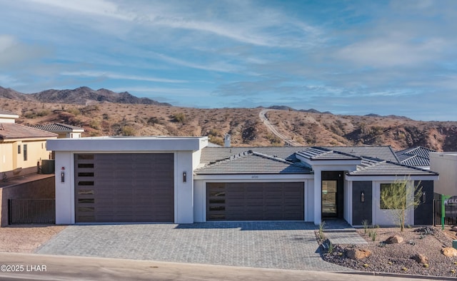 view of front facade featuring a mountain view and a garage