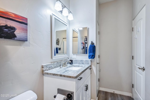 2950 N Kiowa Blvd Unit B102, Lake Havasu City, AZ 86404 - half bathroom featuring vanity, toilet, wood finished floors, and baseboards