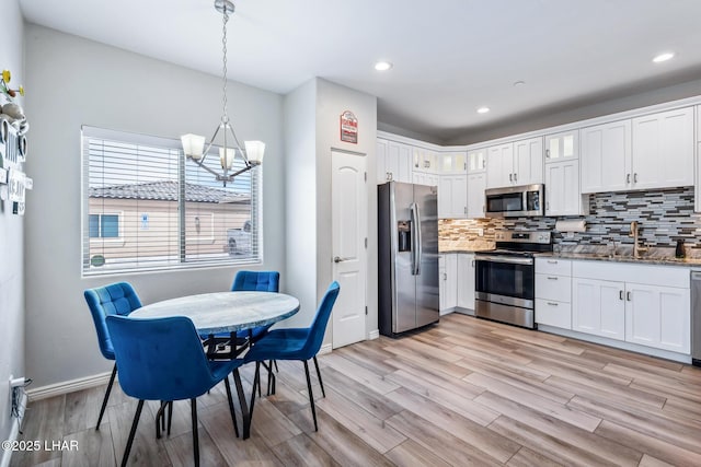 2950 N Kiowa Blvd Unit B102, Lake Havasu City, AZ 86404 - kitchen featuring appliances with stainless steel finishes, a chandelier, backsplash, a sink, and recessed lighting