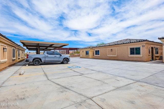 2950 N Kiowa Blvd Unit B102, Lake Havasu City, AZ 86404 - view of front of house featuring uncovered parking, a tile roof, and stucco siding