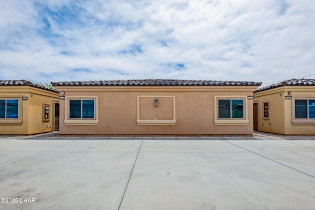 2950 N Kiowa Blvd Unit B102, Lake Havasu City, AZ 86404 - back of house featuring a tiled roof, stucco siding, and a patio