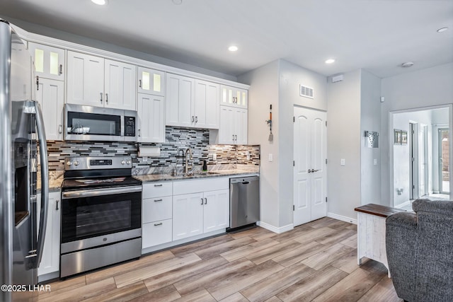 2950 N Kiowa Blvd Unit B102, Lake Havasu City, AZ 86404 - kitchen featuring appliances with stainless steel finishes, a sink, white cabinets, tasteful backsplash, and recessed lighting