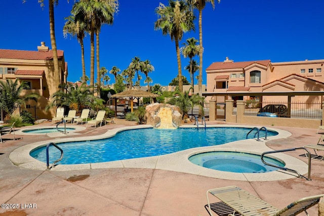 view of swimming pool featuring a patio area and a community hot tub