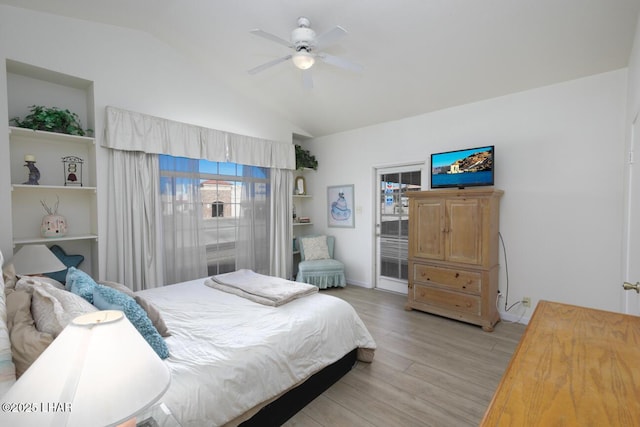 bedroom with ceiling fan, lofted ceiling, and light hardwood / wood-style flooring