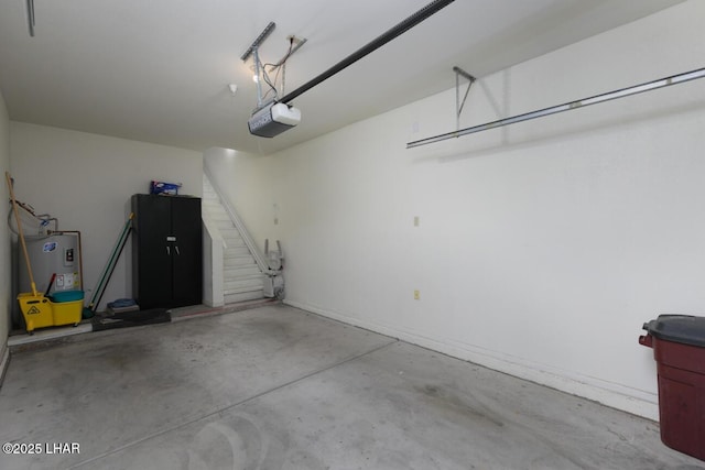 garage featuring a garage door opener and electric water heater