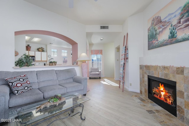 living room with light hardwood / wood-style flooring and a tile fireplace