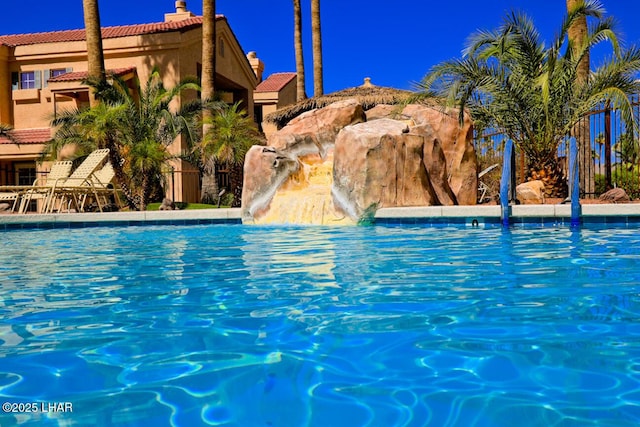 view of swimming pool featuring pool water feature