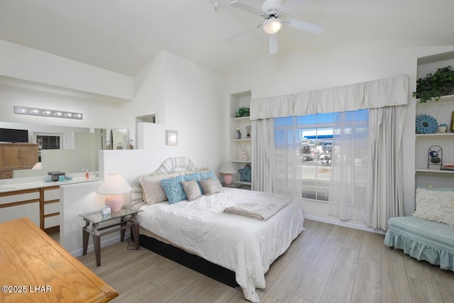 bedroom with lofted ceiling, ceiling fan, and light wood-type flooring