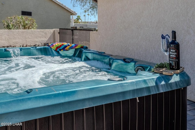 exterior space with an outdoor hot tub