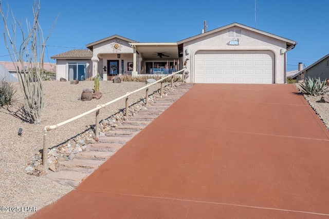 view of front facade with a garage, concrete driveway, and stucco siding