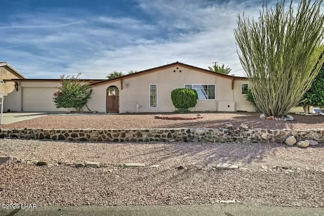 ranch-style home featuring a garage