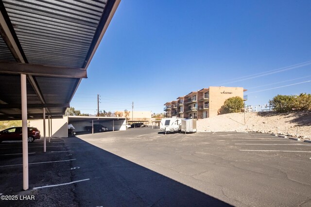 view of vehicle parking with a carport