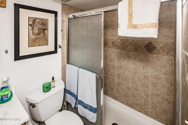 bathroom with vanity, a shower with shower door, and toilet