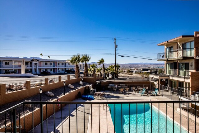 view of swimming pool with a patio and a mountain view