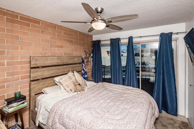 bedroom featuring brick wall, ceiling fan, carpet, and a textured ceiling