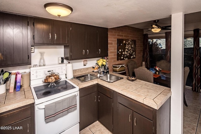 kitchen featuring ceiling fan, dark brown cabinetry, white electric range, and light tile patterned floors