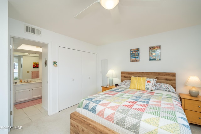 565 Jones Dr Unit 3B, Lake Havasu City, AZ 86406 - bedroom featuring a closet, light carpet, a sink, a ceiling fan, and light tile patterned floors