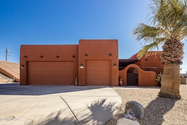 pueblo-style home featuring a garage