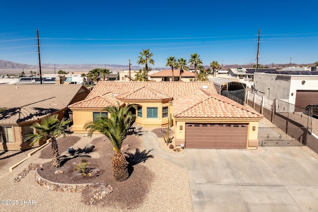 2641 Palo Verde Blvd N, Lake Havasu City, AZ 86404 - mediterranean / spanish home featuring a garage, a tile roof, and stucco siding