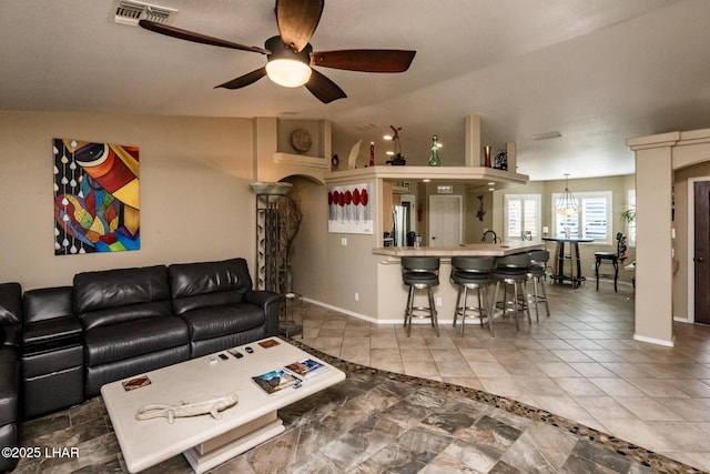 2641 Palo Verde Blvd N, Lake Havasu City, AZ 86404 - tiled living room with arched walkways, lofted ceiling, visible vents, a ceiling fan, and baseboards