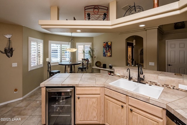 2641 Palo Verde Blvd N, Lake Havasu City, AZ 86404 - kitchen with stainless steel dishwasher, light brown cabinetry, light tile patterned flooring, a sink, and beverage cooler