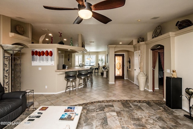 2641 Palo Verde Blvd N, Lake Havasu City, AZ 86404 - living room featuring a ceiling fan, arched walkways, vaulted ceiling, and baseboards